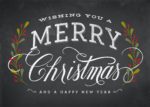 "Wishing you a merry Christmas and a happy new year" on a chalkboard background.