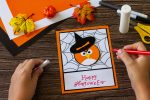 Greeting card for Halloween on a wooden table. Childrens art project, handmade, crafts for children.