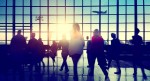 A photo of an airline terminal with a jet in the background and people in the foreground.