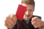 A man holding a red business card.