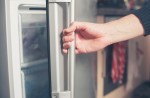 A person opening a refrigerator.