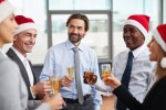 A group of office employees celebrating the holiday season with champagne.