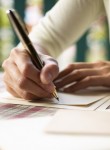 A woman writing on paper.