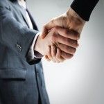 A close up of two business people shaking hands.