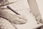 A woman writing in a notebook.